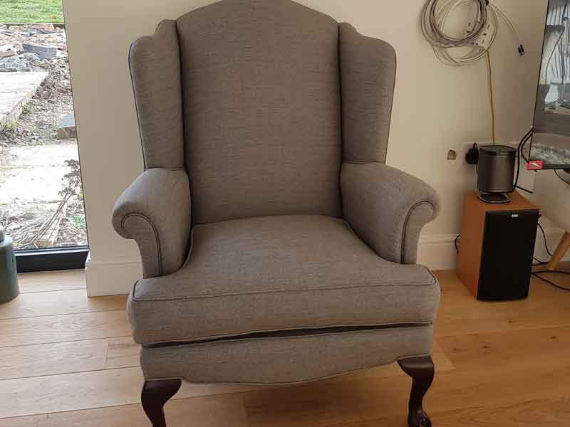 Reupholstered grey winged chair